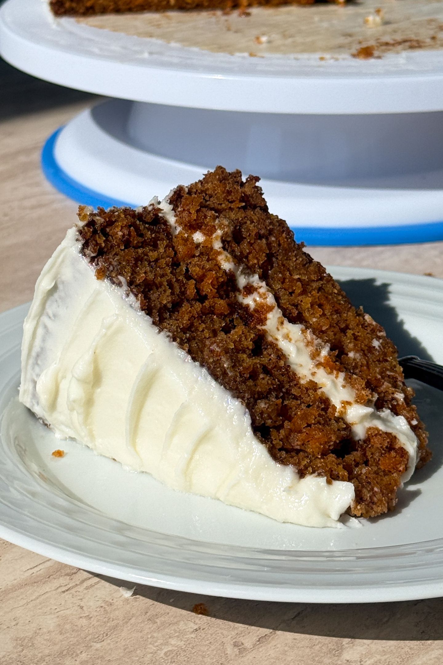 Slice of a two layer carrot cake on a plate.