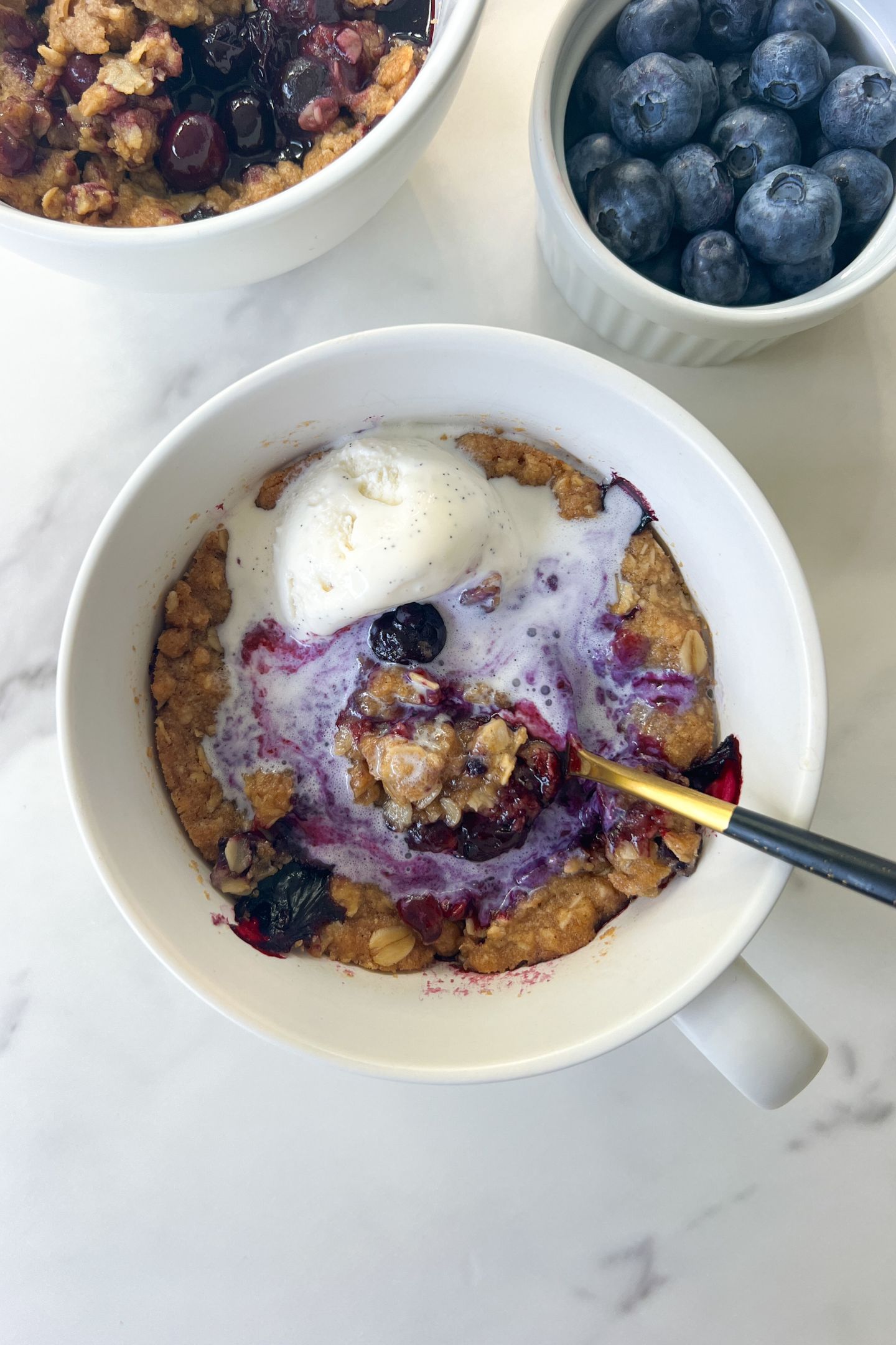 Eating a Gluten Free Blueberry Crisp topped with vanilla ice cream.