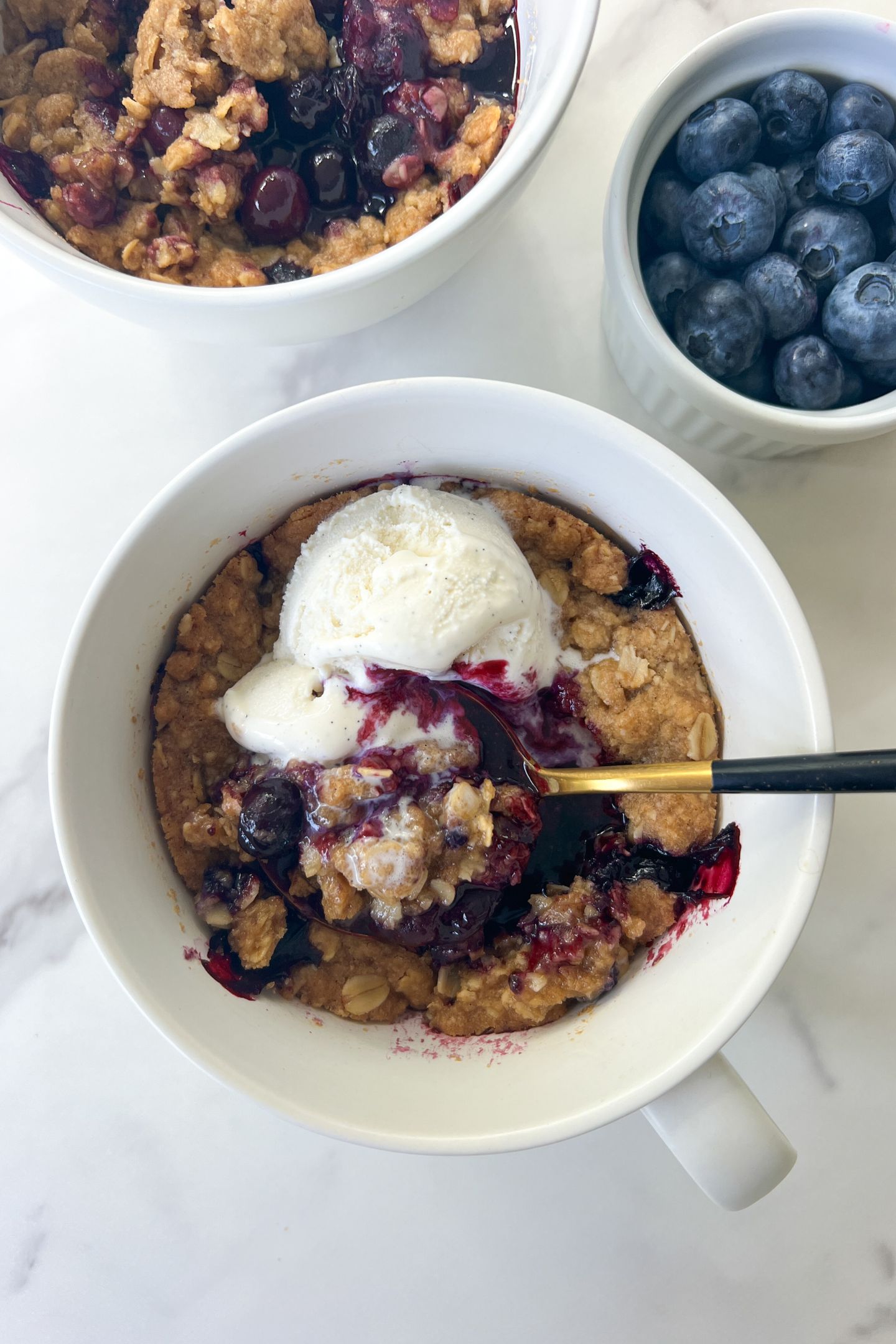 Blueberry Crisp topped with vanilla ice cream.