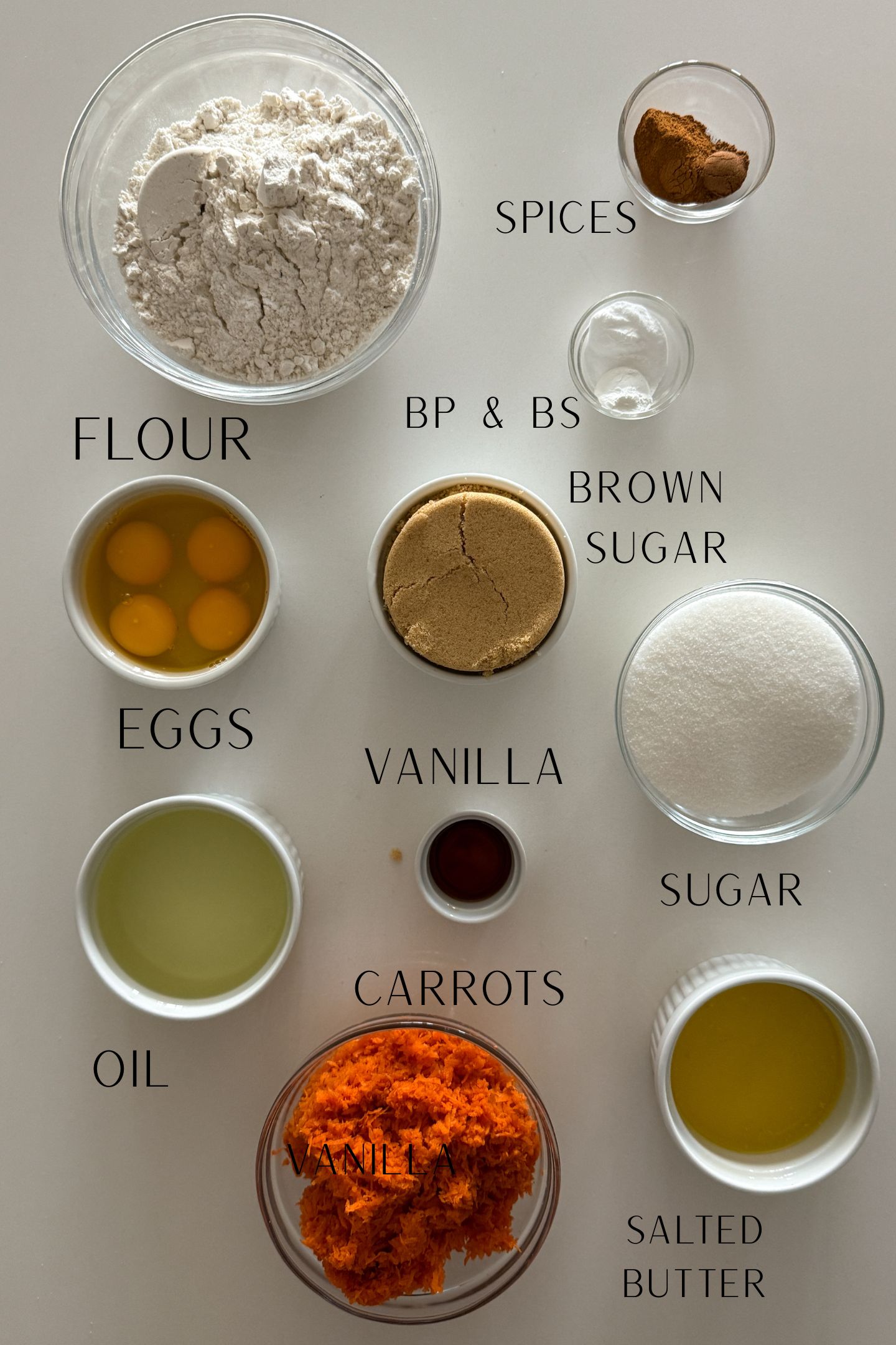 Ingredients measured out in bowls to make the gluten free carrot cake.