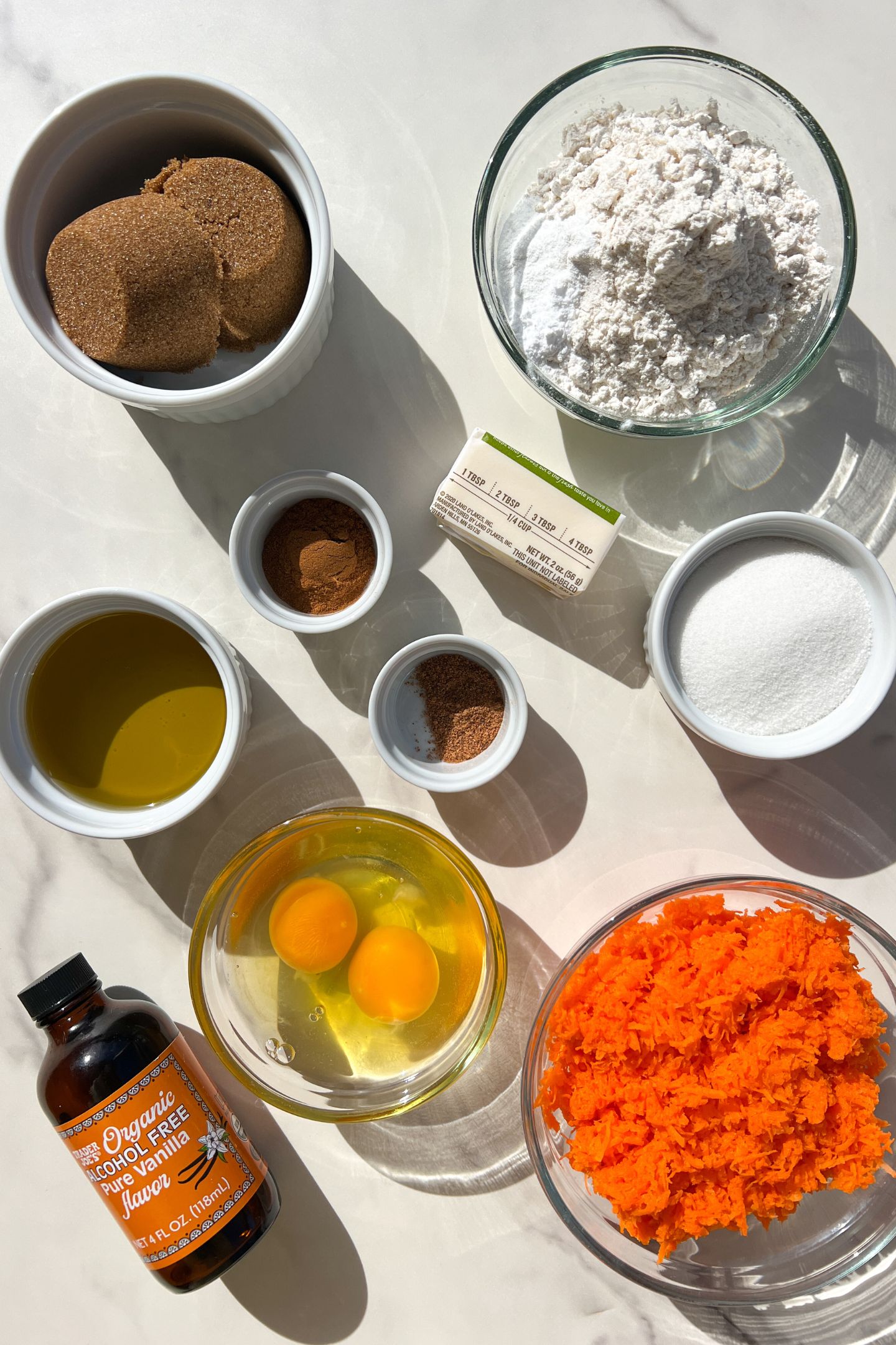 Ingredients measured out in bowls to make Gluten Free Carrot Cake.