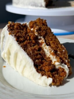 Slice of a two layer carrot cake on a plate.