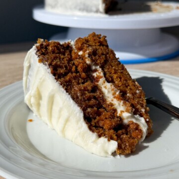 Slice of a two layer carrot cake on a plate.