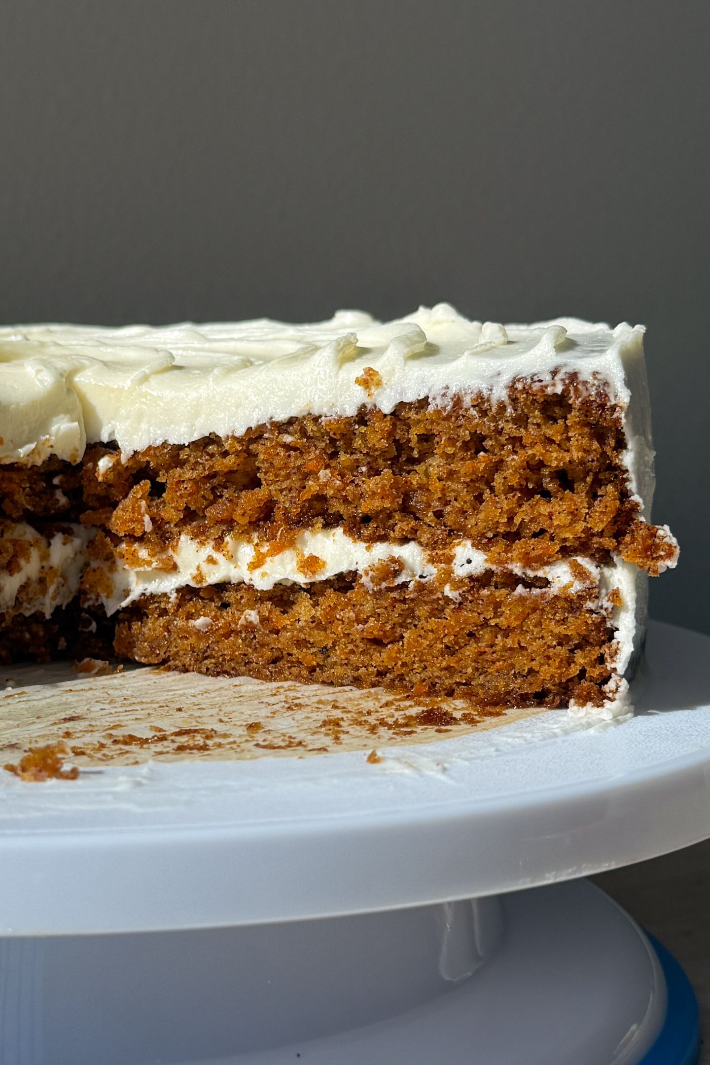 The gluten-free carrot cake sliced open on the cake stand.