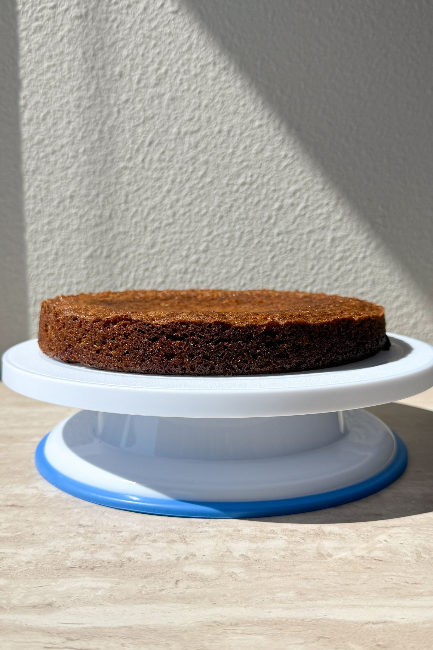 Carrot cake layer on a cake stand.