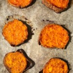 Roasted sweet potato slices on a baking sheet.