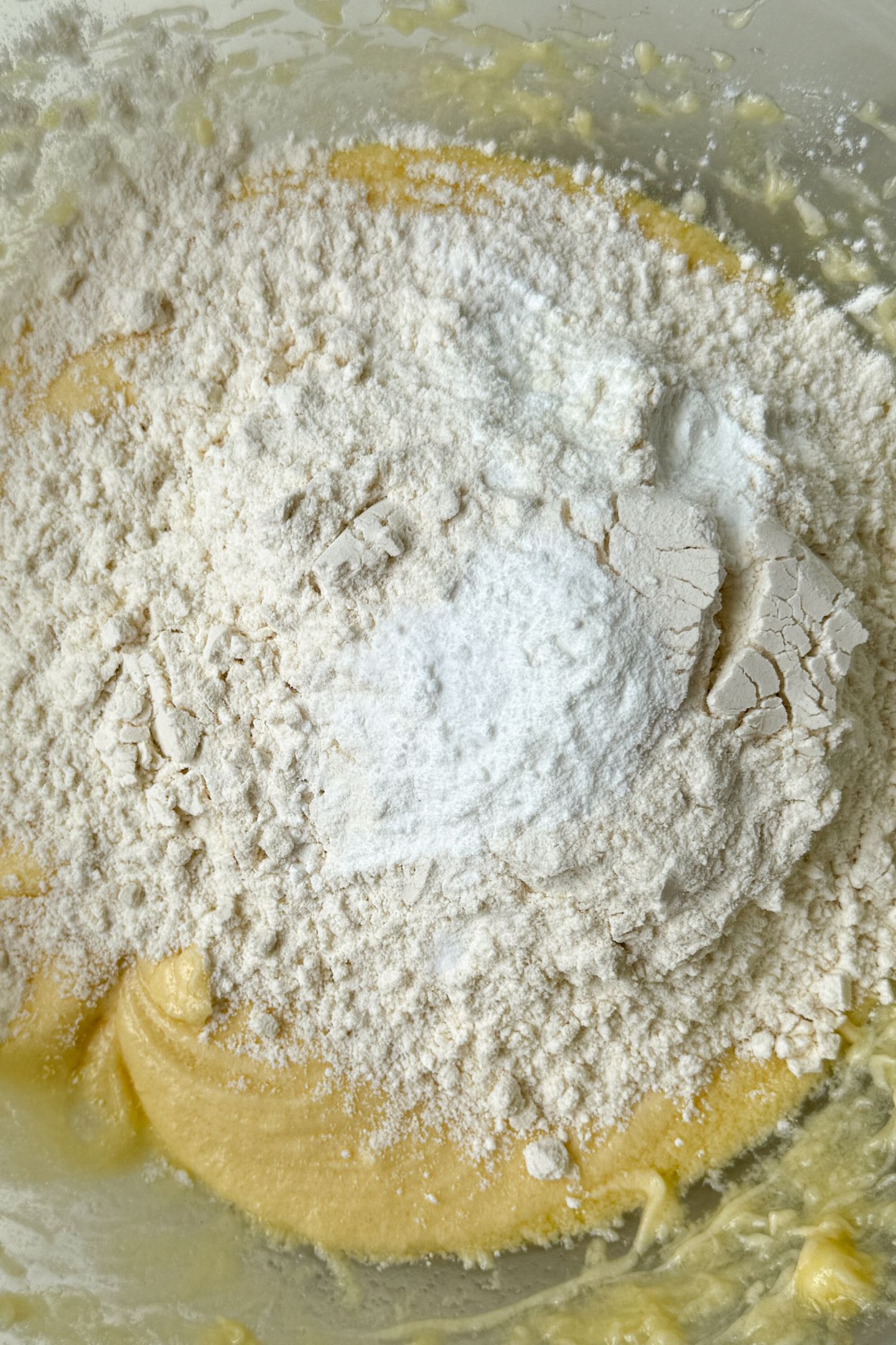 Wet ingredients combined in a bowl and topped with dry.