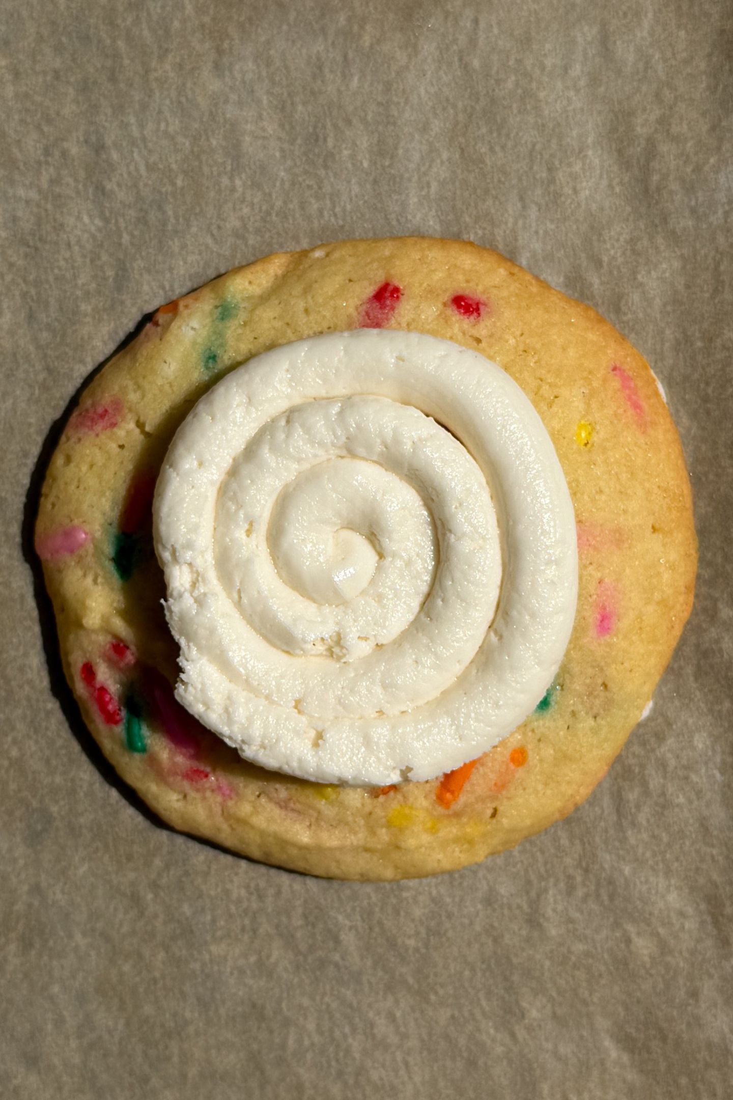 Vanilla buttercream frosting piped on the cookie.