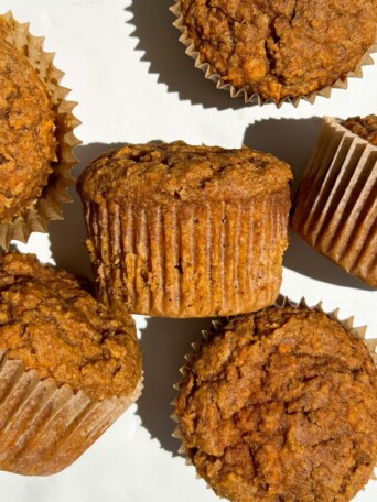 Carrot muffins with and without their wrapper.