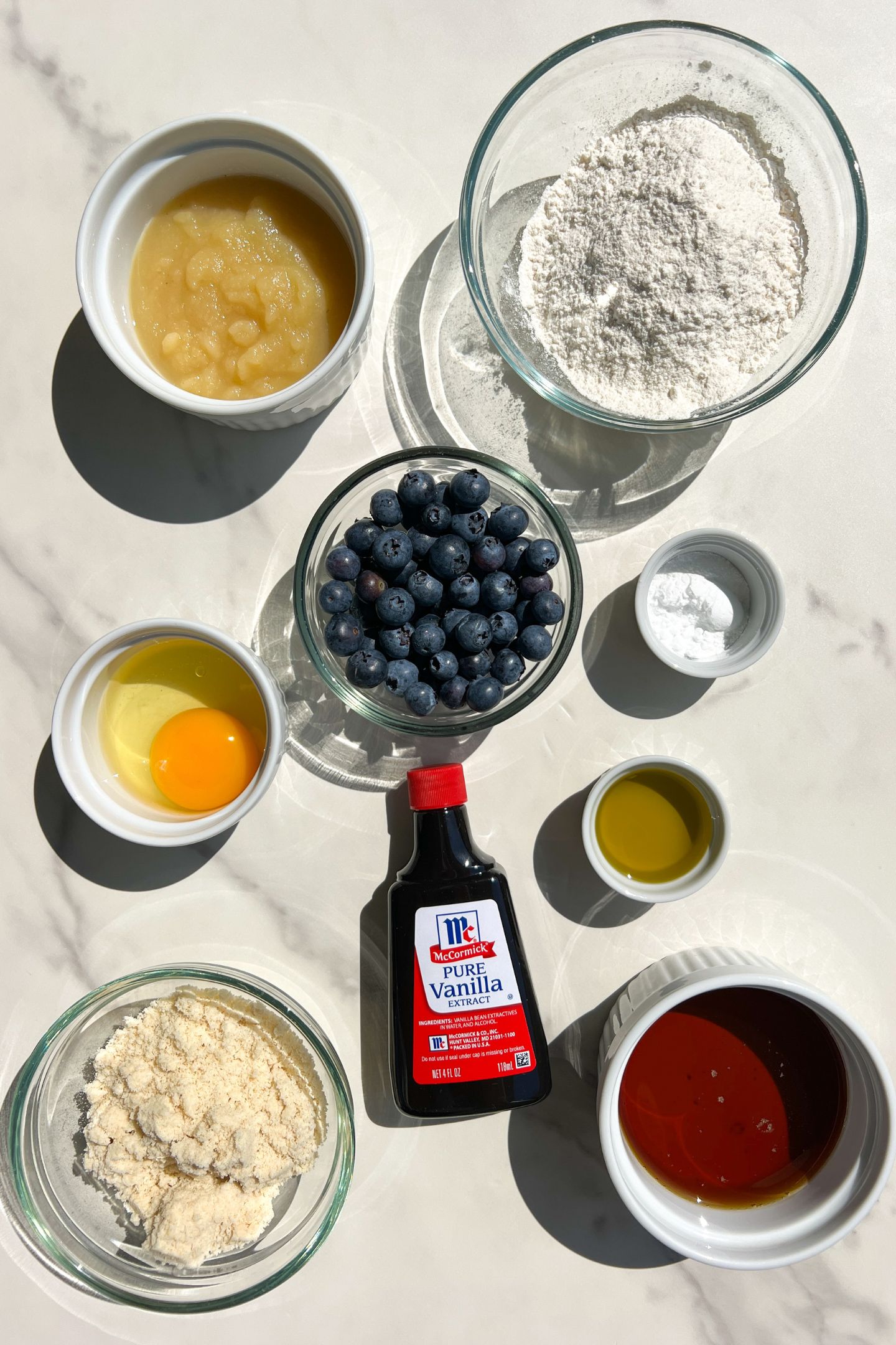Ingredients measured out in bowls to make mini blueberry muffins.