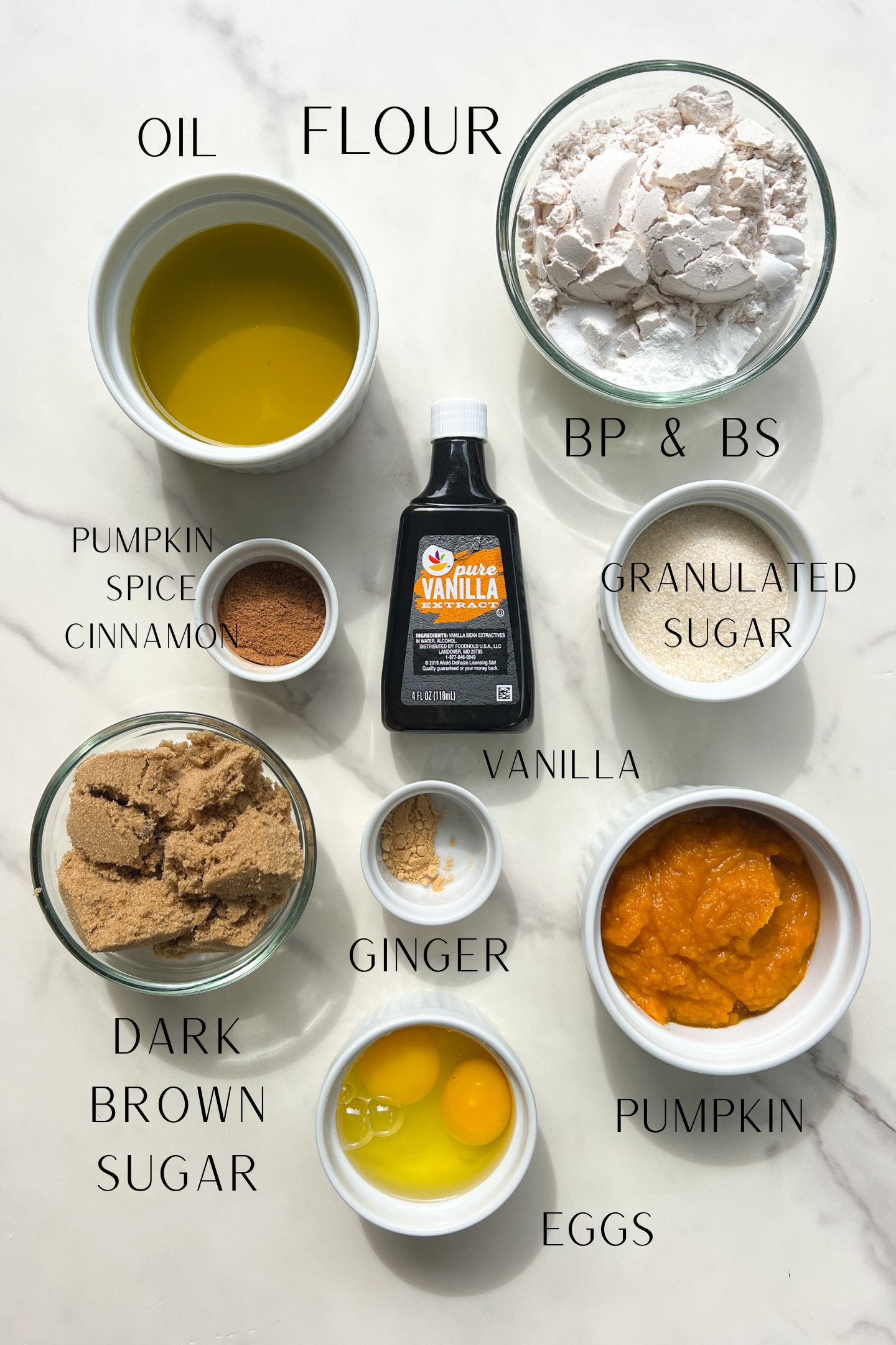 Ingredients measured out in bowls to make the pumpkin cupcakes.