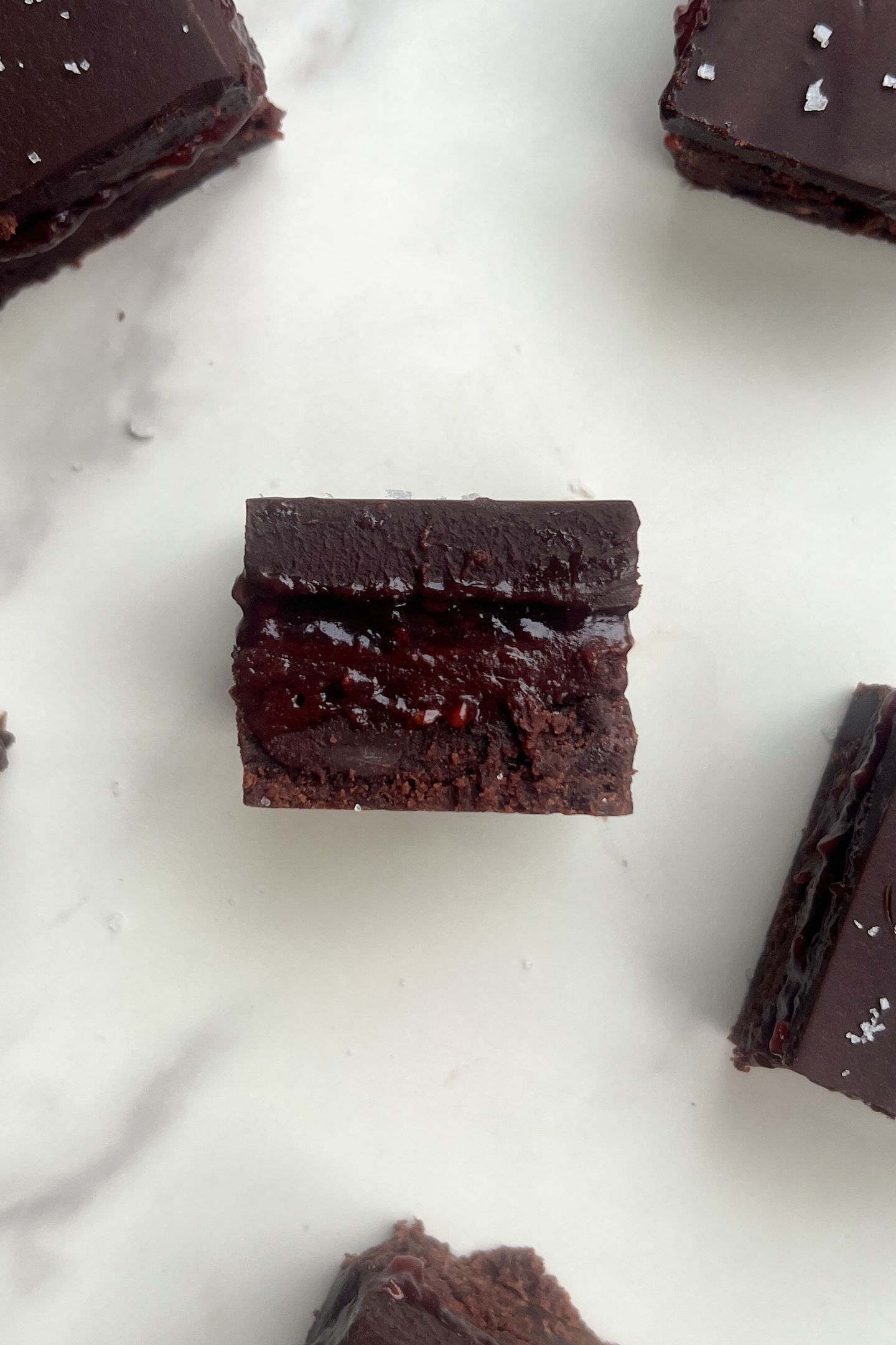 Ganache brownies with a layer of raspberry jam.