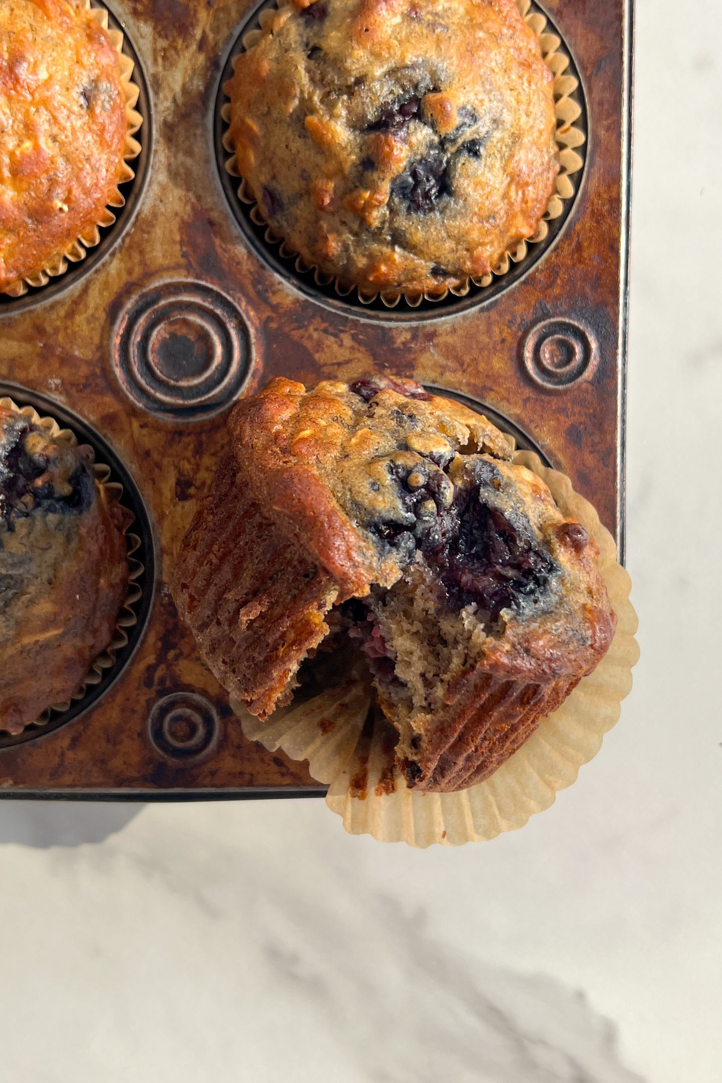 Opened Banana and Blackberry muffin in the wrapper.