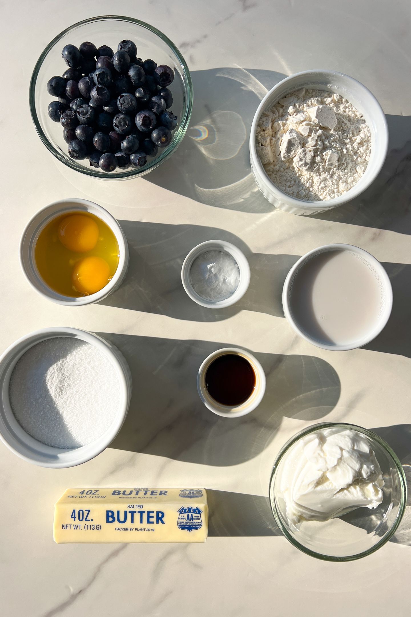 Ingredients measured out in bowls to make blueberry muffins.