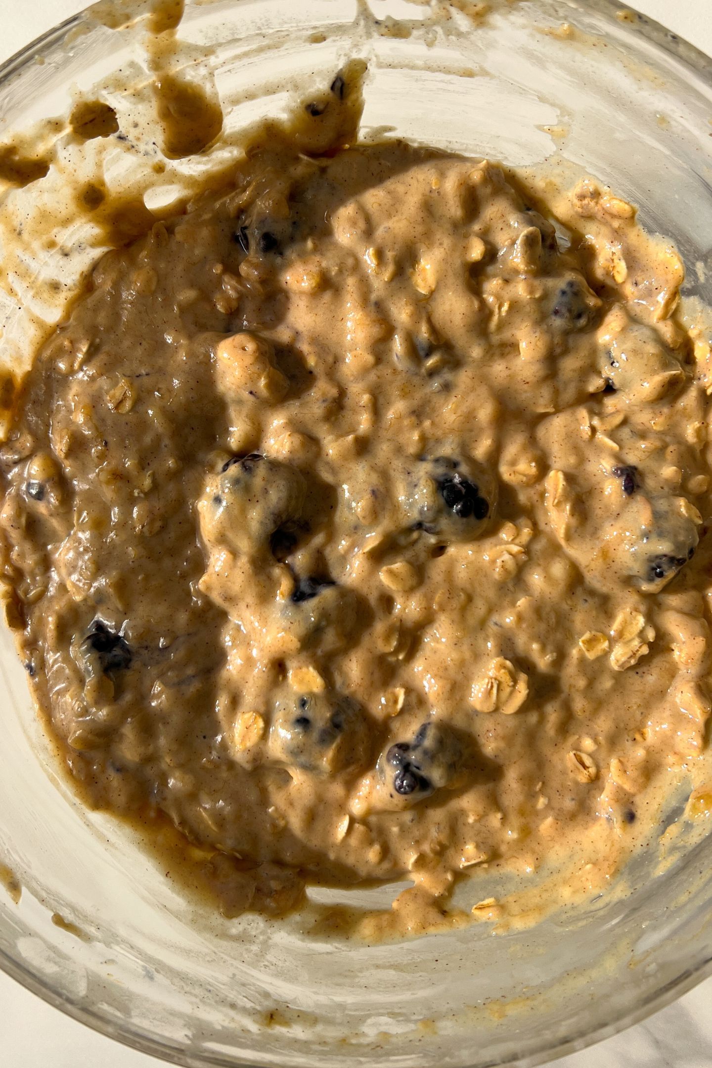 Blackberries in the muffin batter in a bowl.