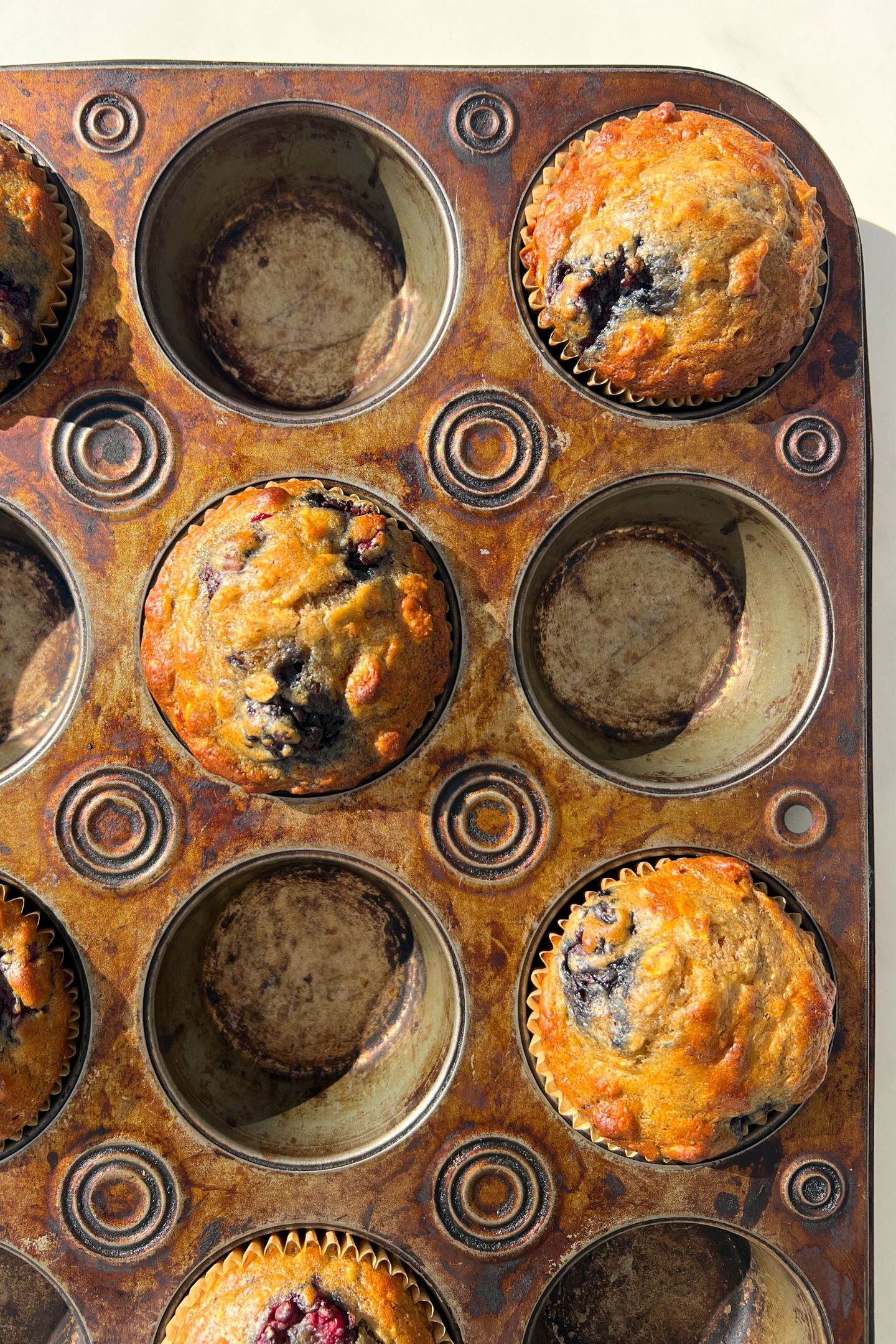 Freshly baked muffins in tray.