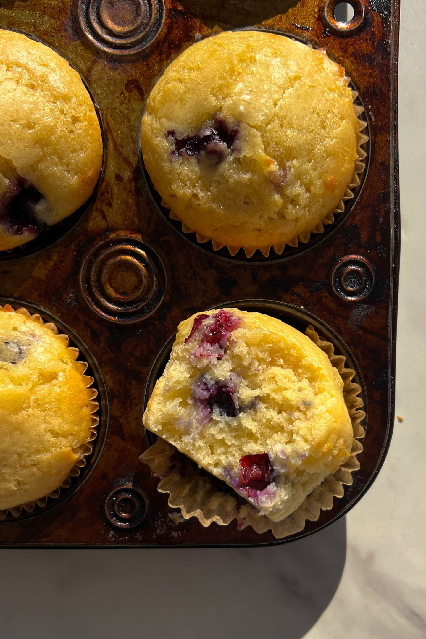 Lemon Blueberry Muffin with a bite taken out of it.