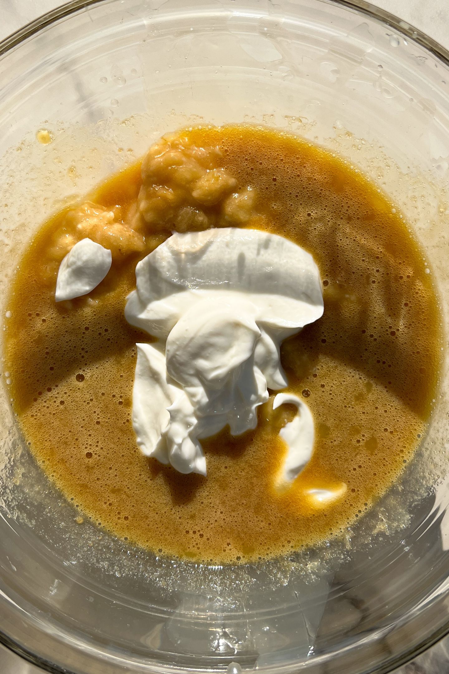 Wet ingredients in a mixing bowl to make the muffin batter.