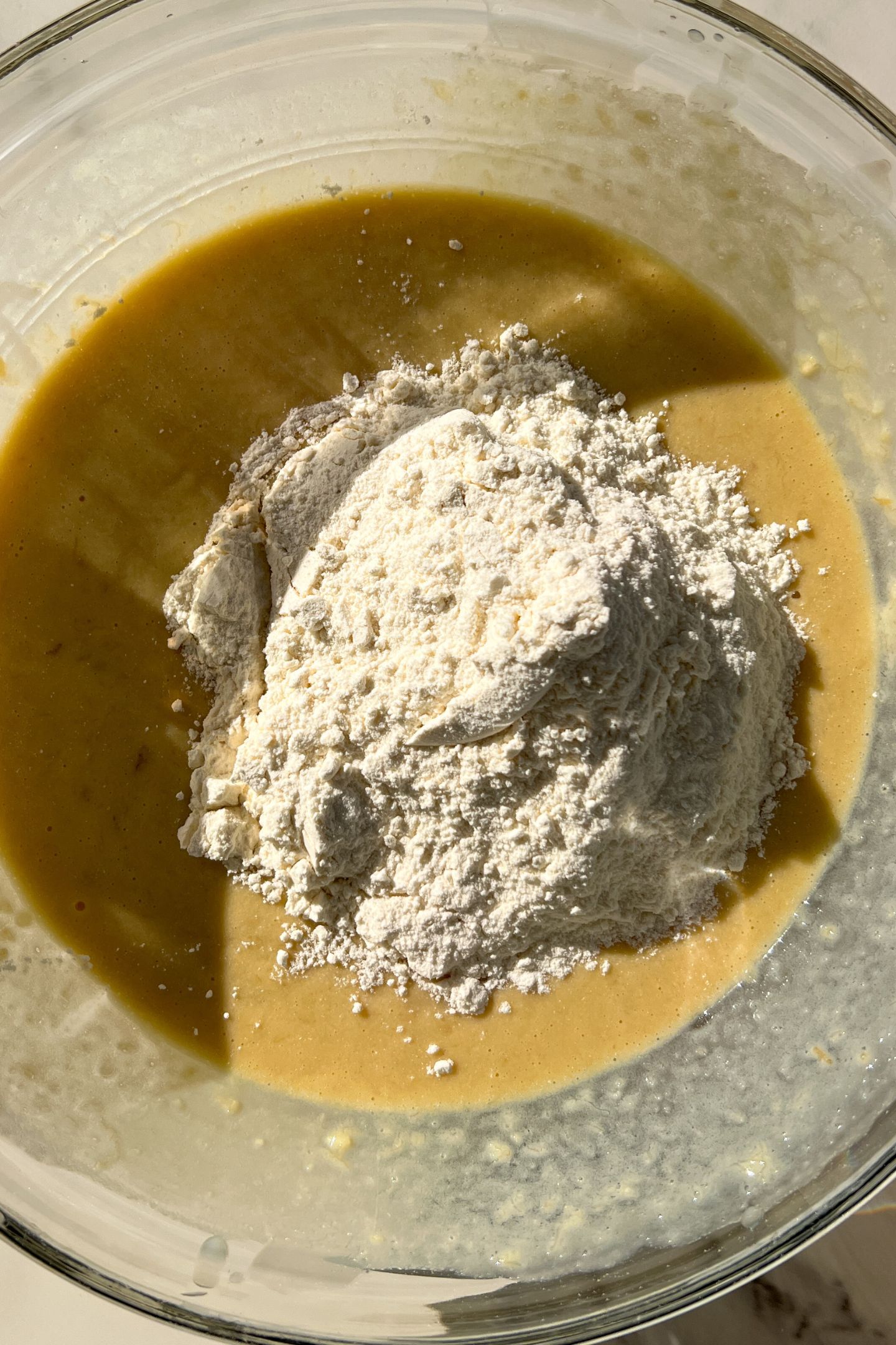Wet and dry ingredients in a mixing bowl to make the muffin batter.