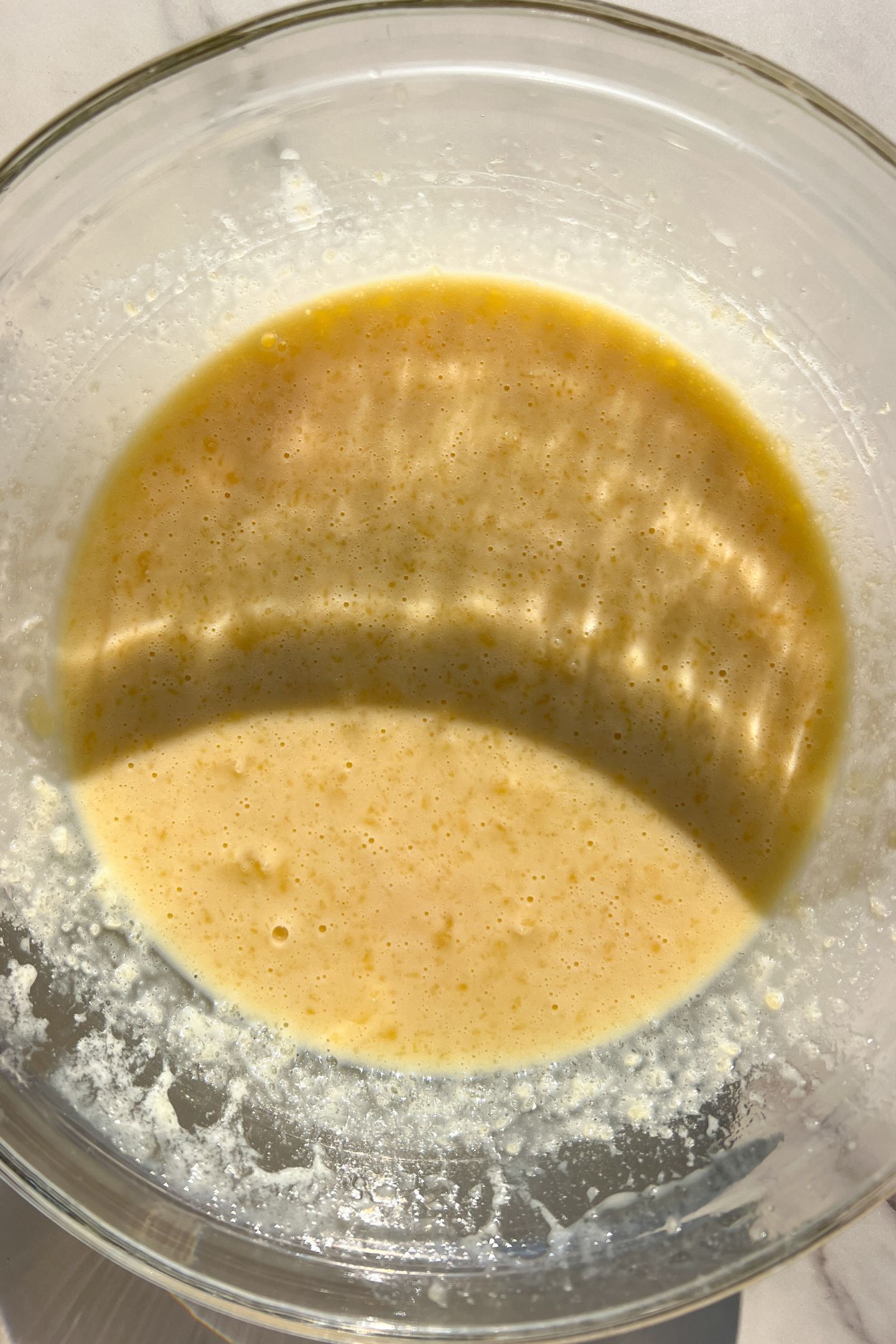 Wet ingredients combined in a large mixing bowl.