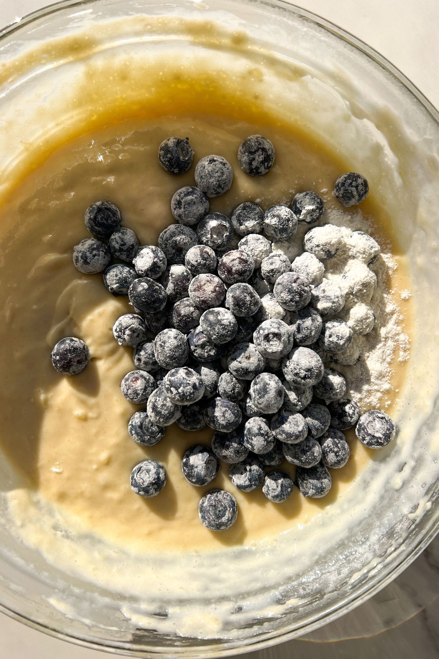 Blueberries being added into the batter.