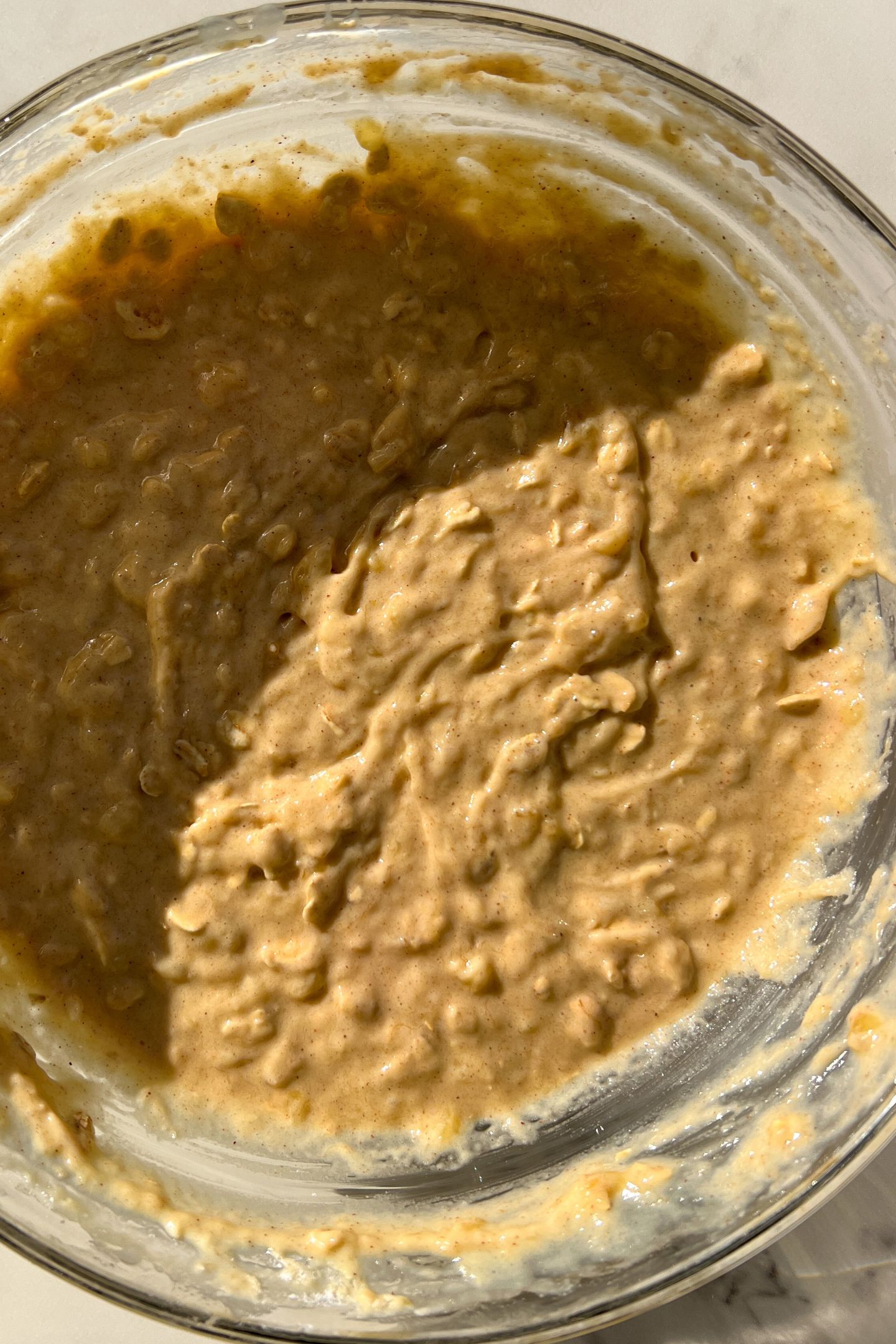 Wet and dry ingredients mixed together in a bowl to make the muffin batter.