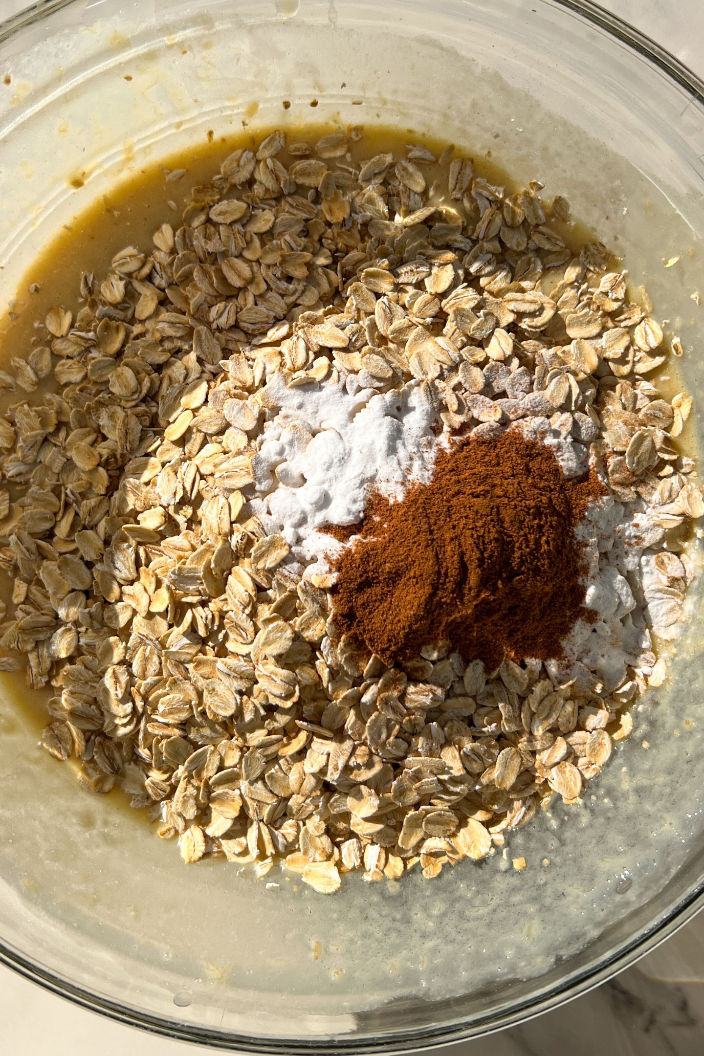 Wet and dry ingredients in a mixing bowl to make the muffin batter.