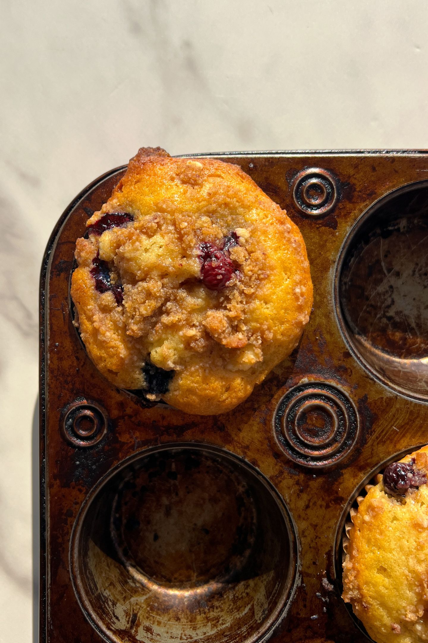 Baked Blueberry muffin in the muffin tin.