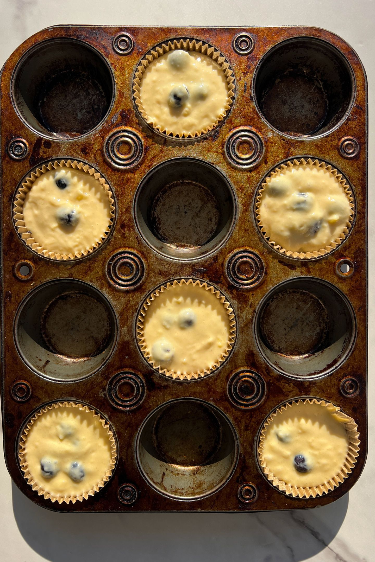 Batter in muffin liners.
