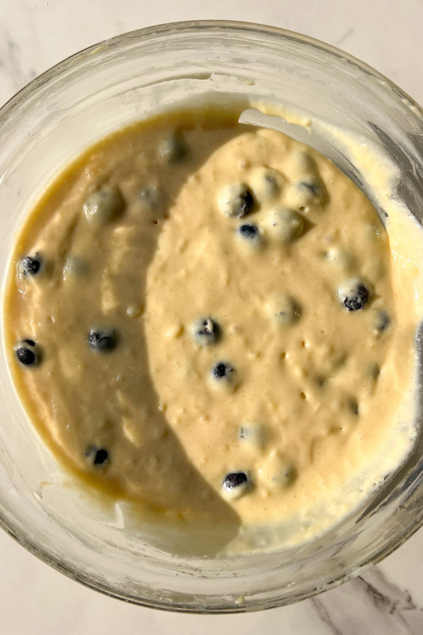 Muffin batter resting in a large mixing bowl.