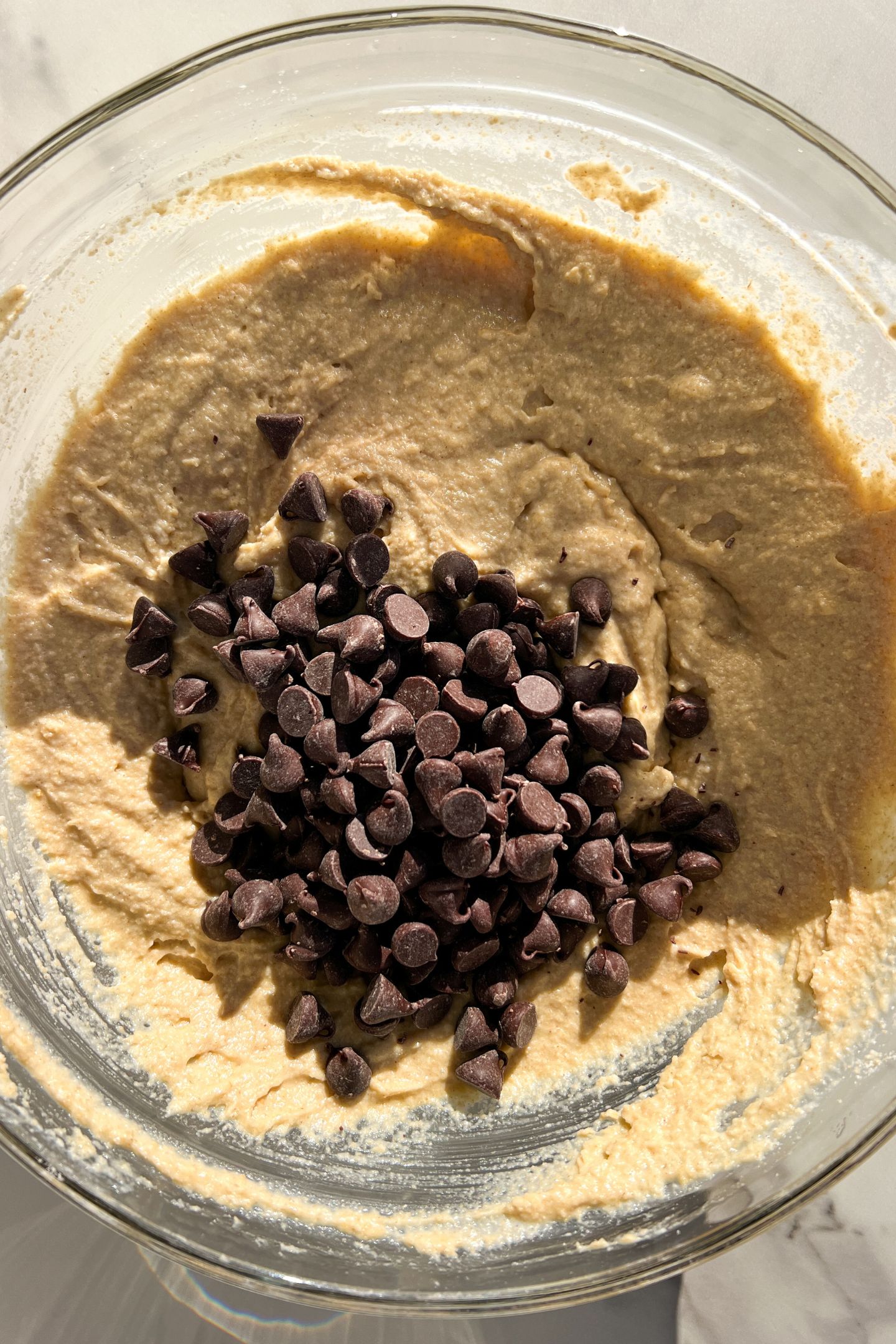 Batter in a bowl topped with chocolate chips.