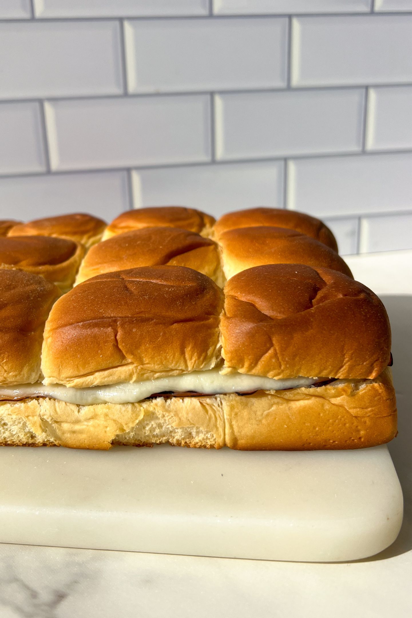 A side view of the Monte Cristo Sliders to show the filing after being baked in the oven.