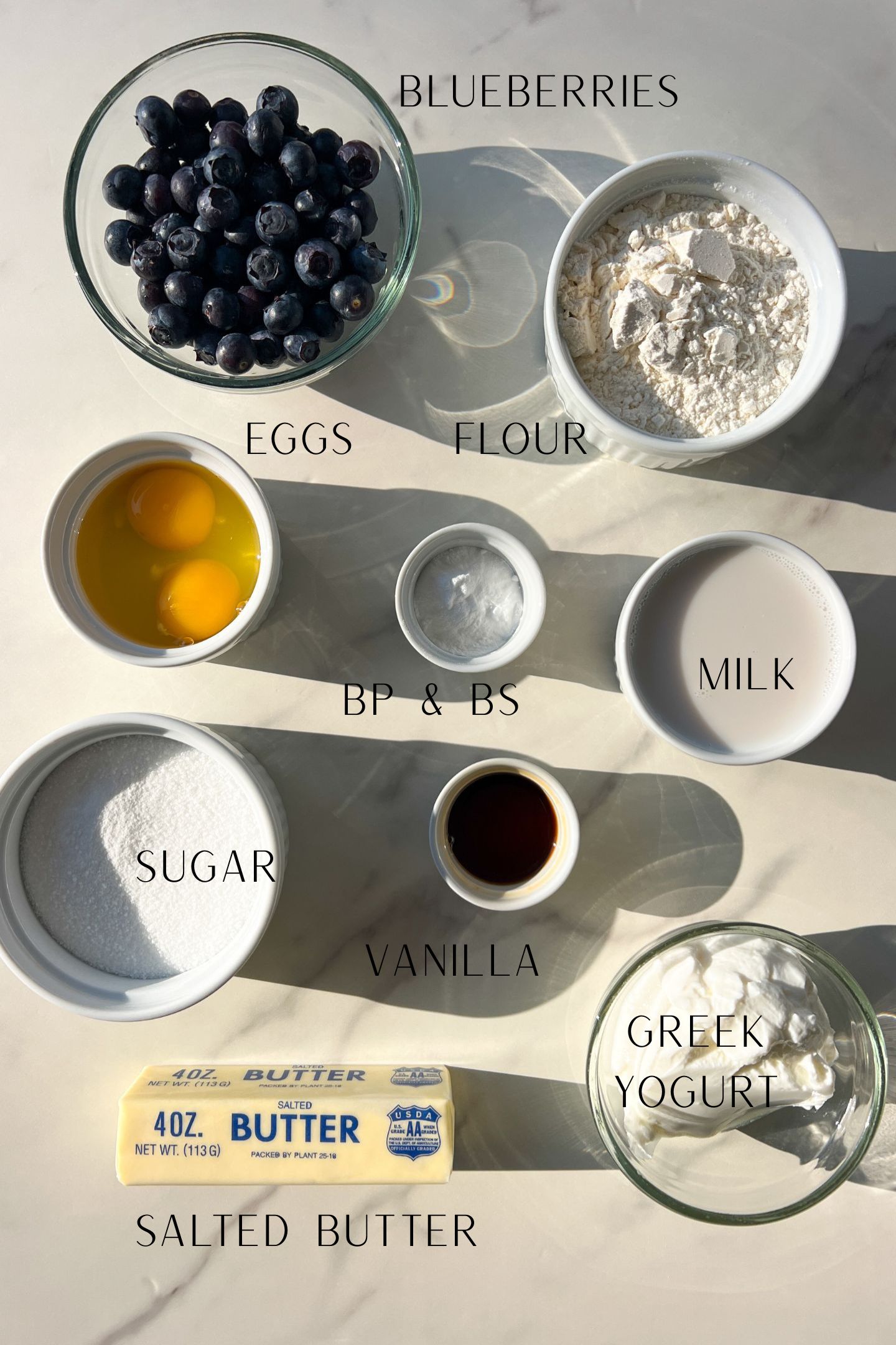 Ingredients measured out in bowls to make blueberry muffins.