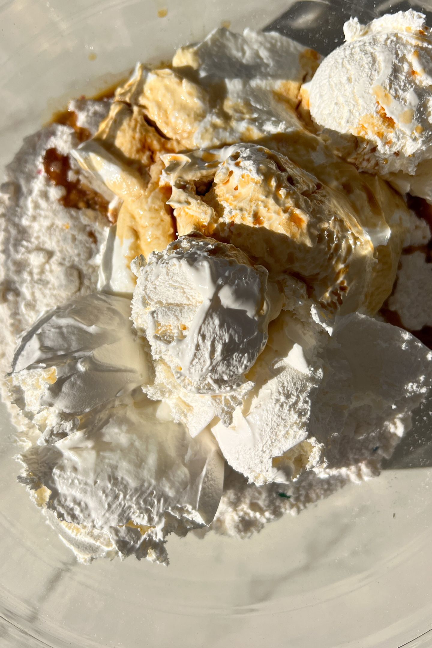 Cake mix, cool whip, vanilla extract and greek yogurt in a bowl.