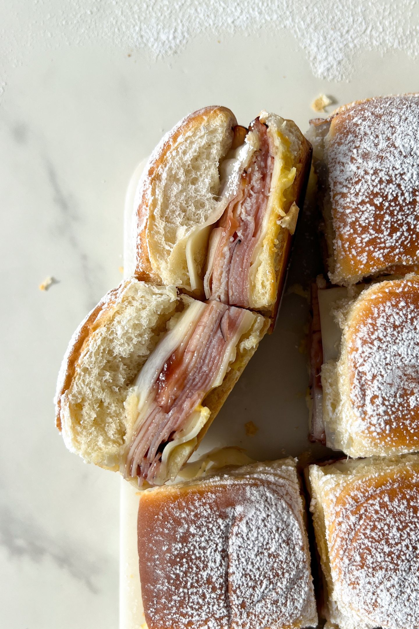 Monte Cristo Sliders on their side and dusted in powder sugar.