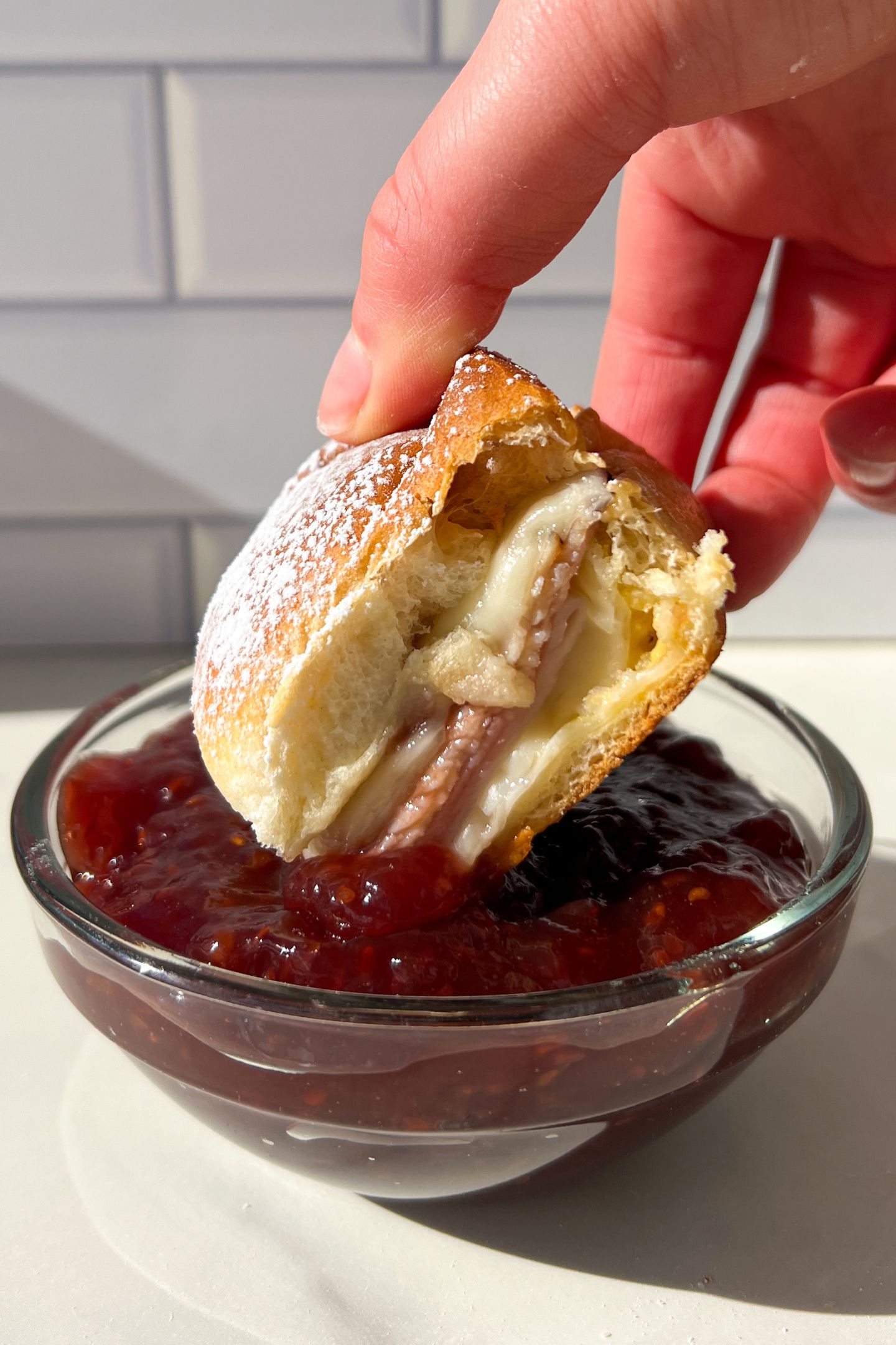 Dipping a Monte Cristo Slider in raspberry jam.