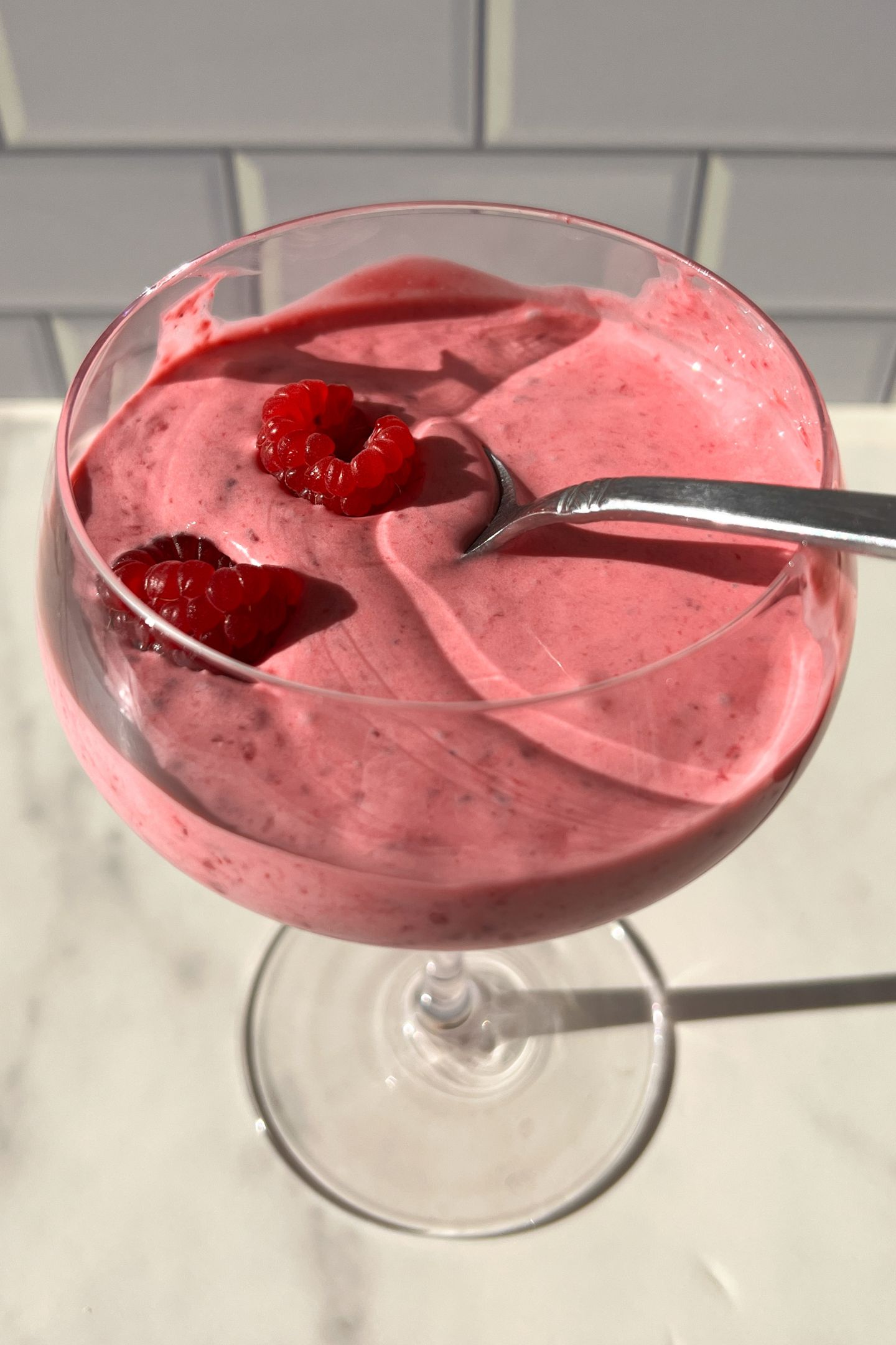 Eating the no bake whipped raspberry cream with a spoon.