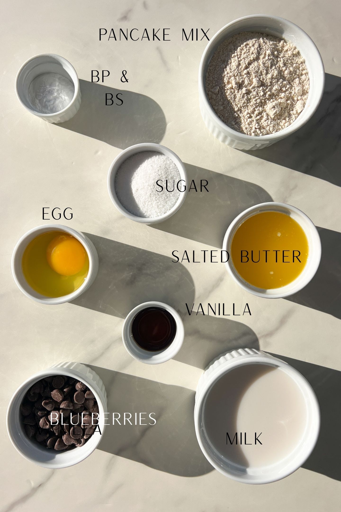 Ingredients measured out in bowls to make the pancake mix muffins.