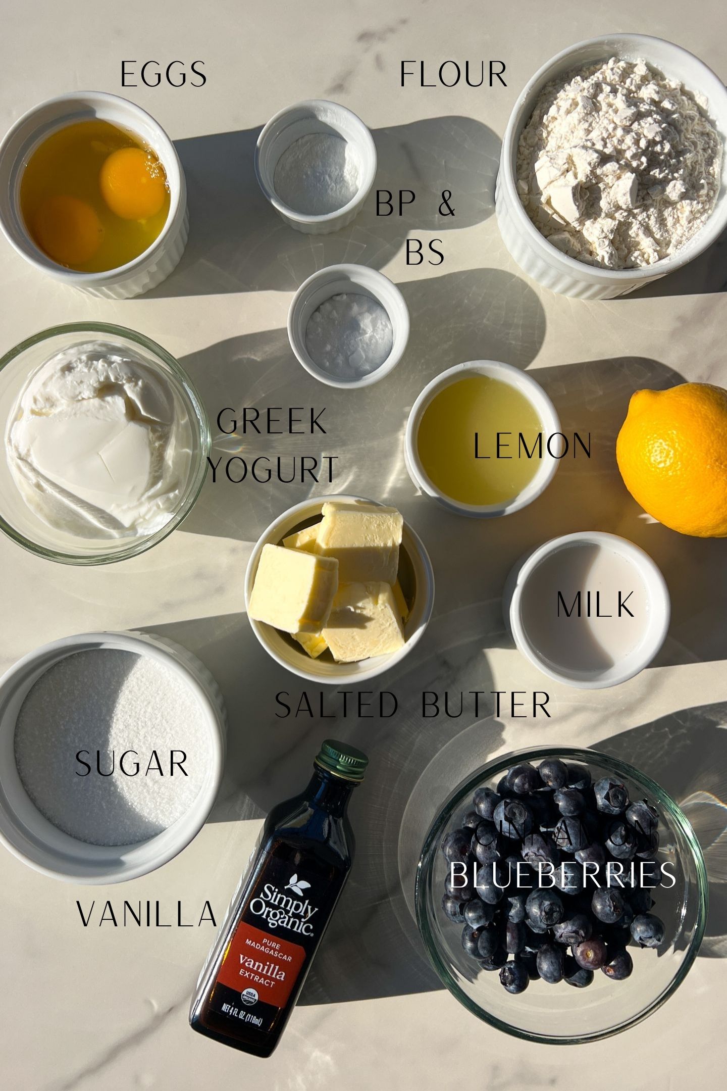 Ingredients measured out in bowls to make Lemon Blueberry Muffins made with greek yogurt.