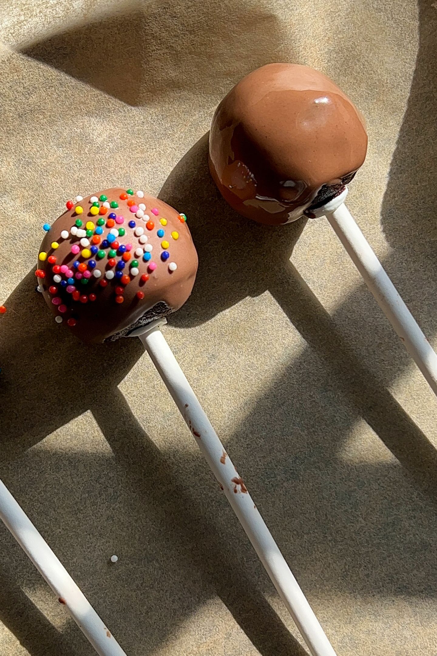 Dipped cake pops on parchment paper.