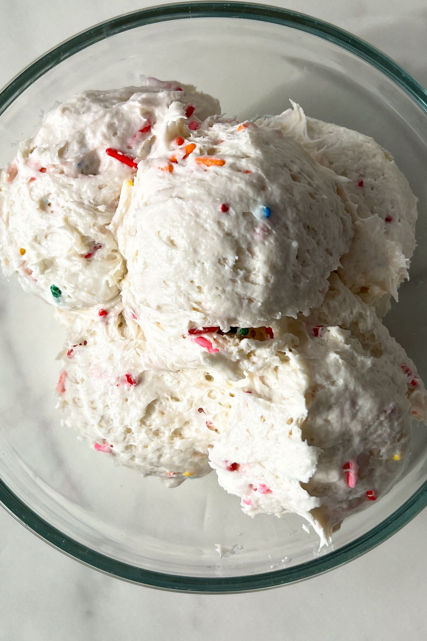 Funfetti Cake Dip being transfered to a serving bowl.