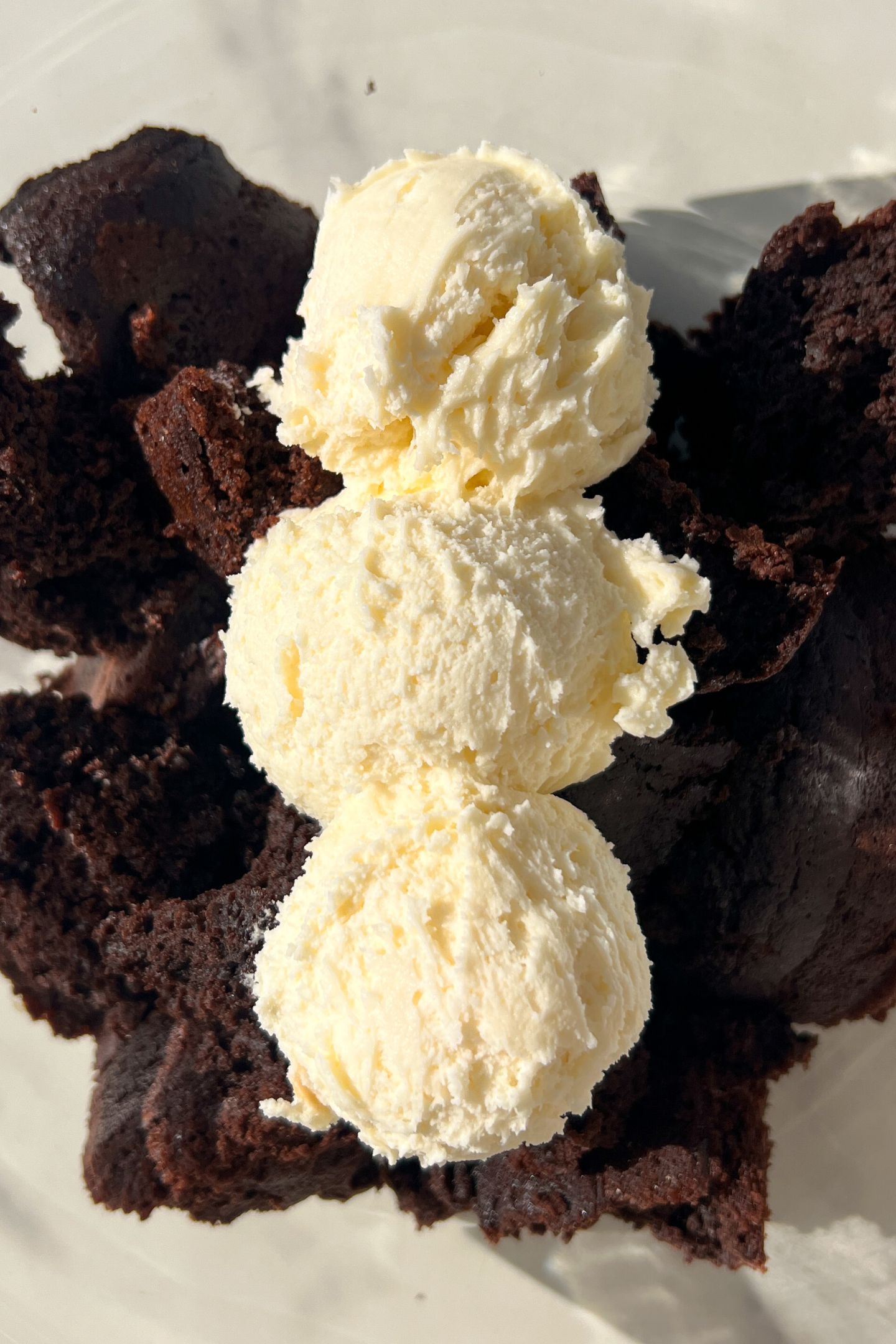 Crumbled up cake in a bowl with frosting.