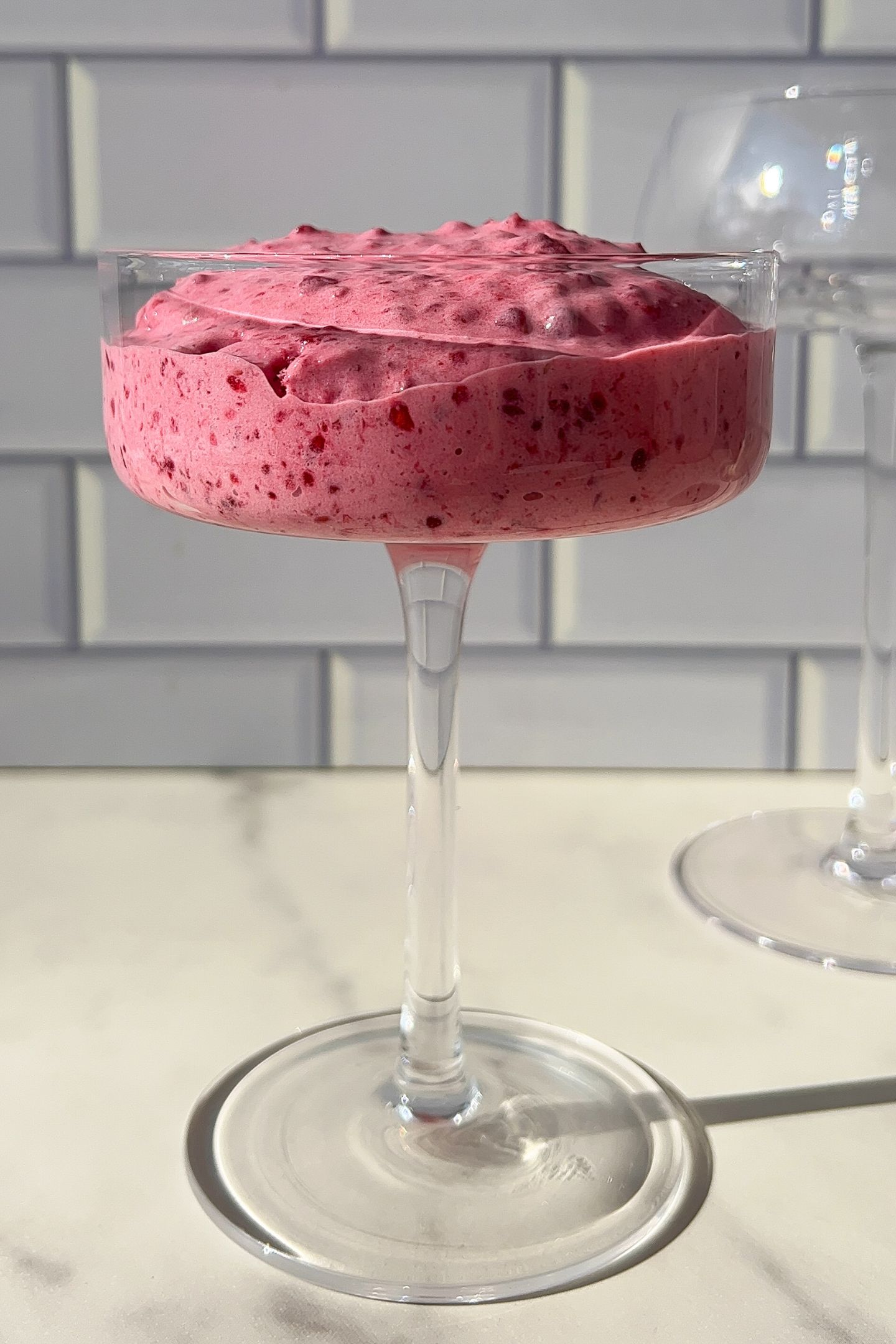 Whipped raspberry cream in a cup.