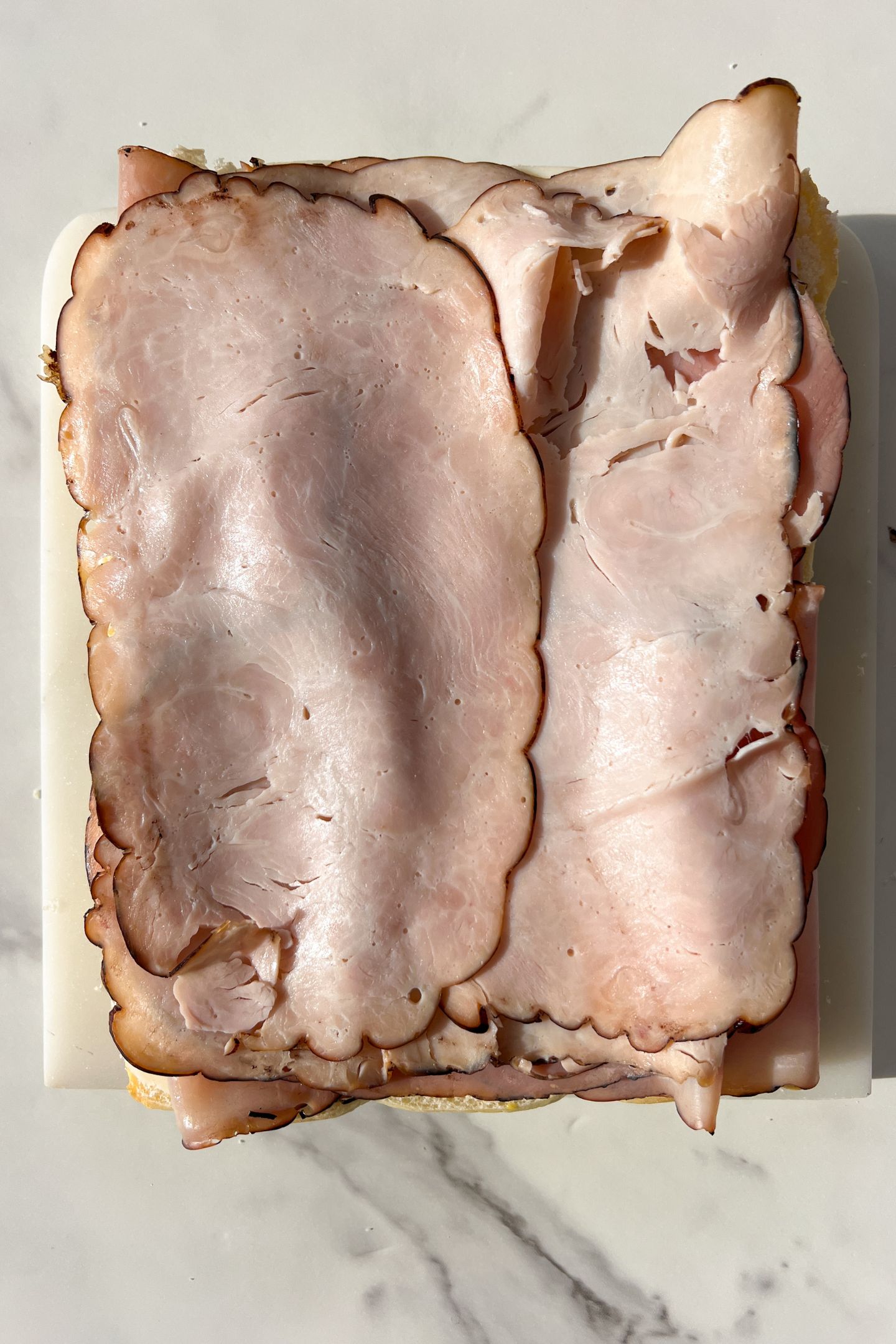 Sliced deli turkey on top of the ham.