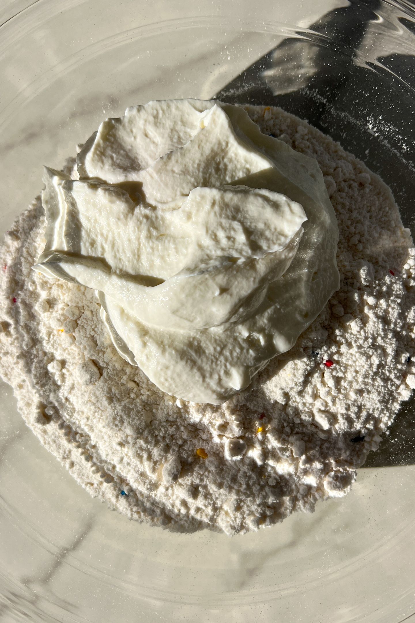 Cake mix and greek yogurt in a bowl.