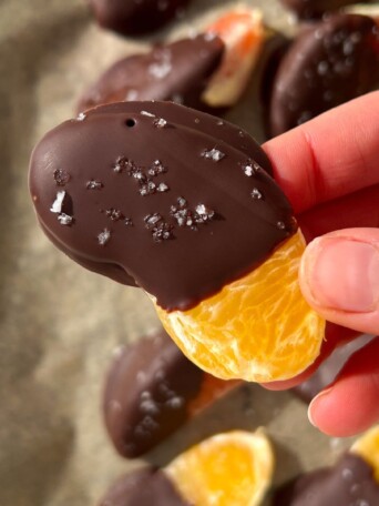Holding a chocolate covered orange slice in my hand.
