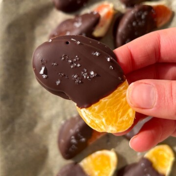 Holding a chocolate covered orange slice in my hand.