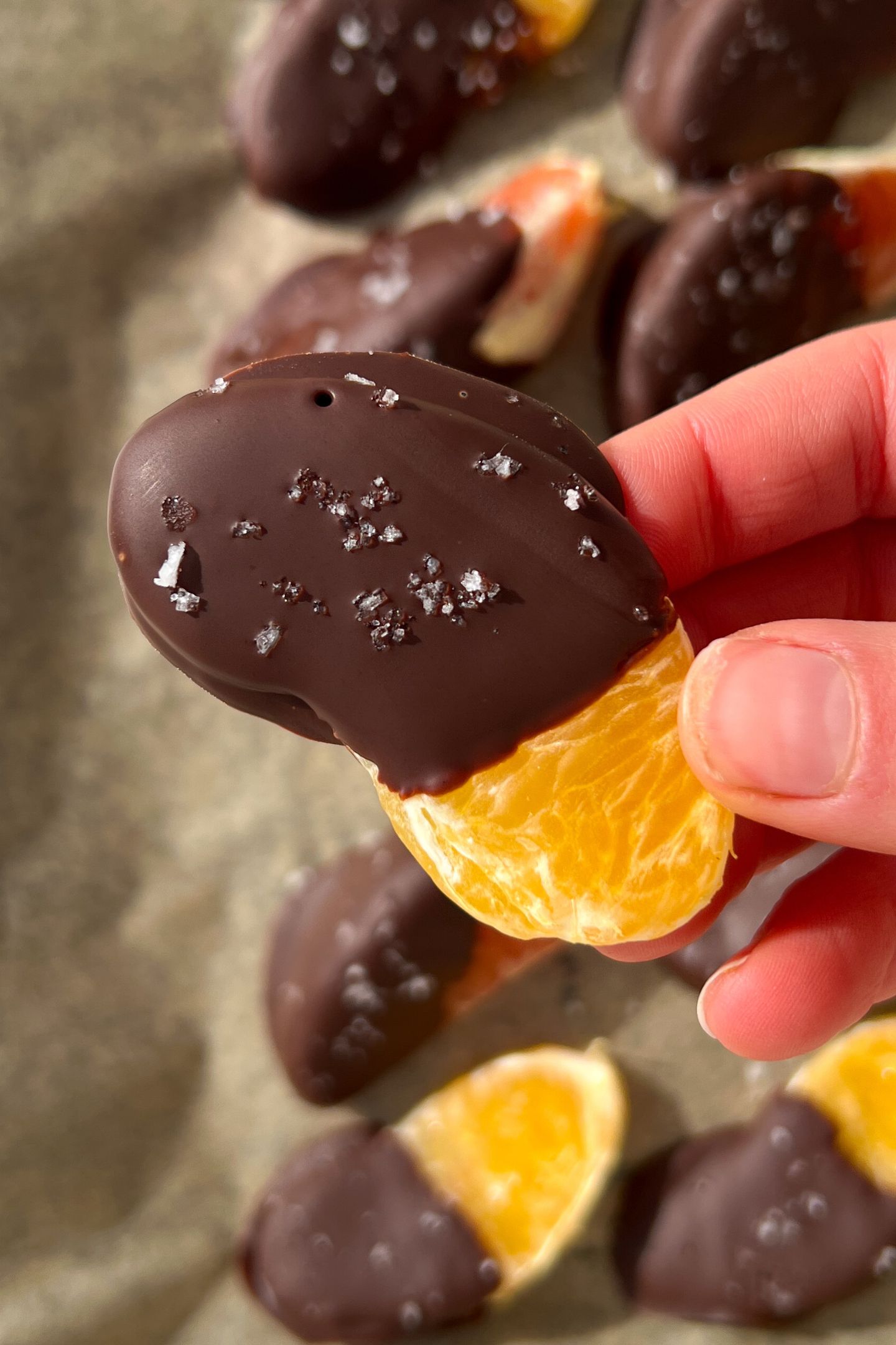 Holding a chocolate covered orange slice in my hand.