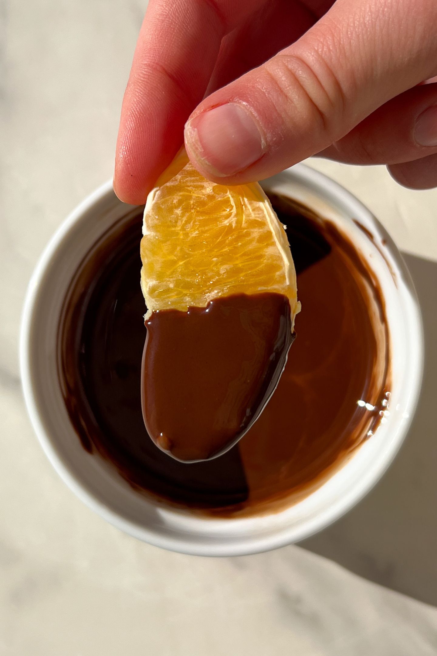 An orange slice dipped in chocolate.
