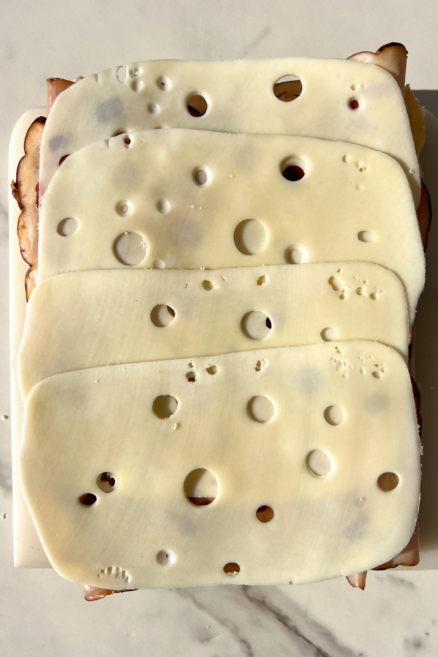Swiss cheese on top of the raspberry jam.
